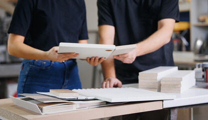 Consultant Woman seller advising client female with color samples and texture for kitchen furniture