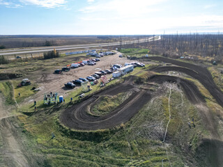 arial photos of racing track birds eye view, clear skies and cars parked