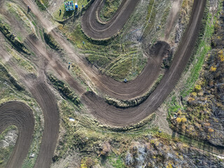 arial photos of racing track birds eye view, clear skies and cars parked
