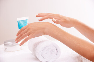 Skincare, lotion and hands closeup in spa, touch and massage for wellness. Fingers, nails and woman apply cream in treatment, natural cosmetics or dermatology moisturizer, beauty health or manicure