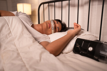 Asia man sleep with Apnea Oxygen Mask Equipment And Cpap Machine	