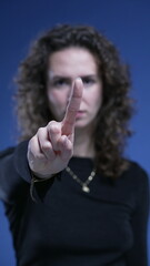 Close-up woman waving FINGER saying NO to camera by rejecting OFFER. stern serious body language of...
