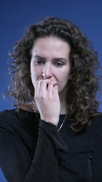Anxious woman biting nails feeling apprehensive about future, struggles with obsessive compulsion in vertical video