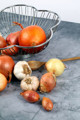 Metal basket with net of onions