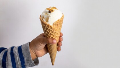 Baby kid hand holding ice cream in waffles cone on white background, text space