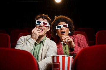 shocked african american woman sitting next to her jolly boyfriend at cinema on date, Valentines day