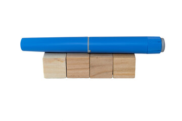 Semaglutide pen lying on blank wooden blocks. healthcare industry concept 