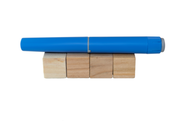 Semaglutide pen lying on blank wooden blocks. healthcare industry concept 