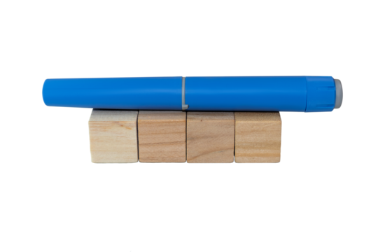 Semaglutide pen lying on blank wooden blocks. healthcare industry concept 