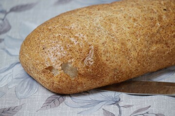 A whole fresh loaf of bread on the table.