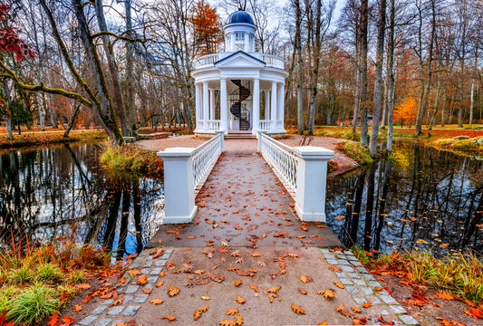 Late autumn colors with pedestrian bridge as foreground  in old public park 