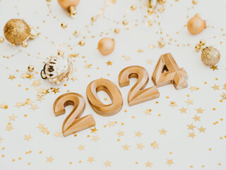 Greeting card - happy new year with numbers 2024 and gold glitter on light background