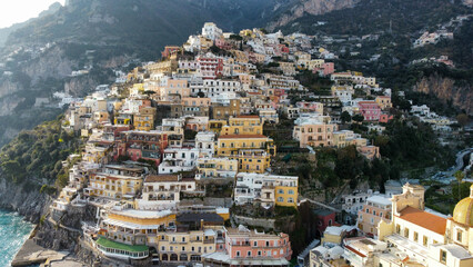 Positano Top view of sea, Positano town and mountains. Turquoise colors, Green, blue sky and Beautiful view at Sunset - obrazy, fototapety, plakaty
