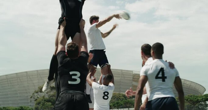 Rugby, teamwork and and catch a ball on field, lineout and sports game with player collaboration. Men, athletes and strong by outdoor for competition training and practice with fitness and workout
