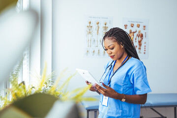 Young medical worker holding tablet computer. Shot of a medical practitioner using a digital tablet in a hospital. Young nurse using digital tablet. Female nurse ....