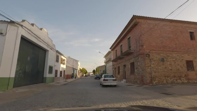 First person view, FPV, from dashcam of car driving in the town of Sallent de Gállego in Huesca, Aragon, Spain. Road trip video in POV, driving at sunrise