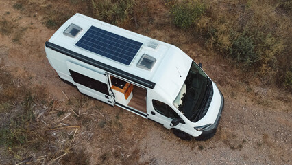 Overhead view of a camper van in which the solar panel on the roof can be seen.
Renewable energy,...