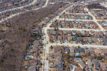 Aerial view of cargo ships on Lake Simcoe near Barrie, Canada, contrasting suburban sprawl with the lake's natural expanse.
