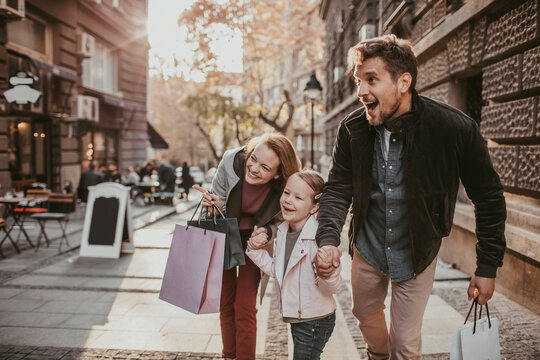 Young Family Shopping In The City