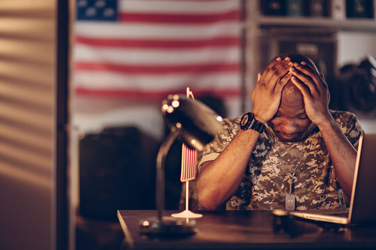 American soldier being tired and missing home while being deployed in an army base