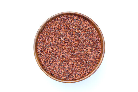 Organic Finger millet or Eleusine coracana in a wooden bowl top view 