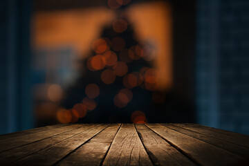 Empty wooden tabletop on blurred light golden bokeh of cafe restaurant bar on empty dark background