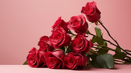 Delicate red roses beautifully arranged on a pale red surface, offering a visually appealing and sophisticated image with copyspace,