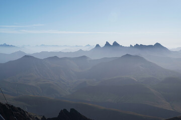 Panorama of Alpine summits in summer under the fog in France in Europe