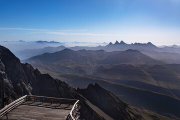 Panorama of Alpine summits in summer under the fog in France in Europe