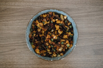Top view of bowl with raisins and candied fruit for fruitcake.