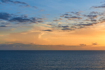 Fototapeta na wymiar cloudy orange sunset low horizon for sky replacement 