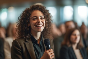 Girl student asking lecturer a question with a microphone at a conference