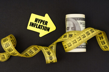 On a black surface there are dollars wrapped in measuring tape and stickers with the inscription -...