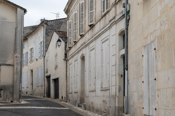 View on old streets and houses in Cognac white wine region, Charente, walking in town Cognac with...
