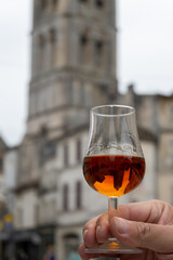 Tasting of cognac alcohol drink and view on old streets and houses in town Cognac, Grand Champagne,...