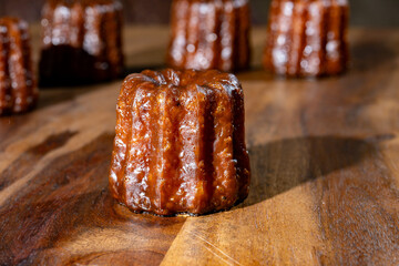 Canele, French pastry flavored with rum and vanilla, soft and tender custard center and  dark,...