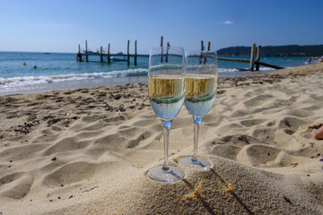 Summer time in Provence, two glasses of cold champagne cremant sparkling wine on famous Pampelonne...