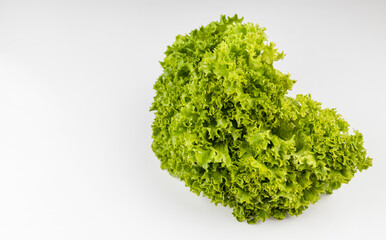 Obraz premium A bunch of green salad on a white table.