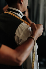 man measuring clothes