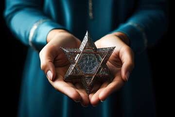 A woman holding an old and rusty star of David in their hands.