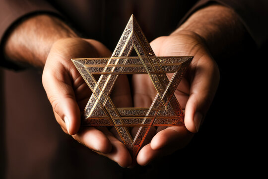 A man holding an old and rusty star of David in their hands.