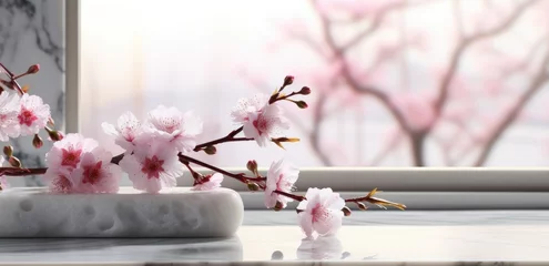 Poster cherry blossoms blooming on a white table with a vase of water © olegganko