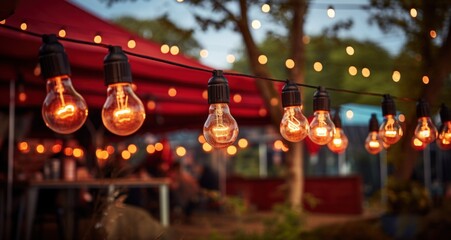 Fototapeta na wymiar fest lights on tents lit at an outdoor event