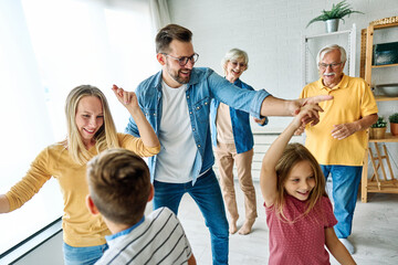 child family woman mother man father grandmother dancing music daughter group happy girl grandparent generation  grandchild together senior grandfather - obrazy, fototapety, plakaty