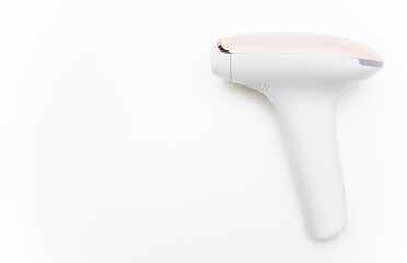 Photo of a pulsed light hair removal gun on a white background.Pulsed light laser.IPL.Copyspace for...