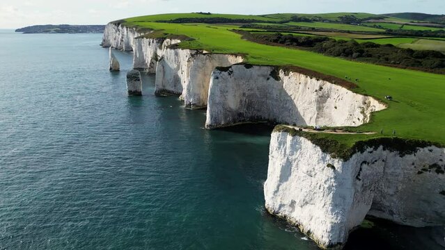 England, Beautiful aerial footage over the white cliffs, Old Harrys Rocks on the south coast of England. United Kingdom landmarks. Aerial landcape and wild nature. 