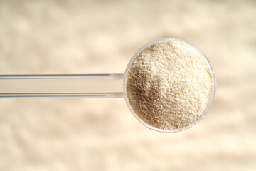 Collagen powder in a plastic measuring scoop