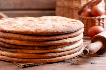 Cooking honey cake at home. Round baked cake layers stacked on a table.