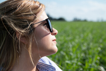 De perfil mujer utilizando gafas de sol