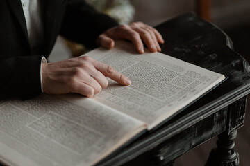 Close-up of man reading the Torah. Close-up of hands on book. Reading the Torah. Hands of a man reading a book, close-up.